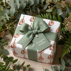 Floral acoustic guitar wrapping paper with sage green ribbon by Wrapped Studios.