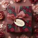 Burgundy floral wrapping paper on a square gift box with sheer ribbon bow; elegant gift wrap for birthdays and special occasions.