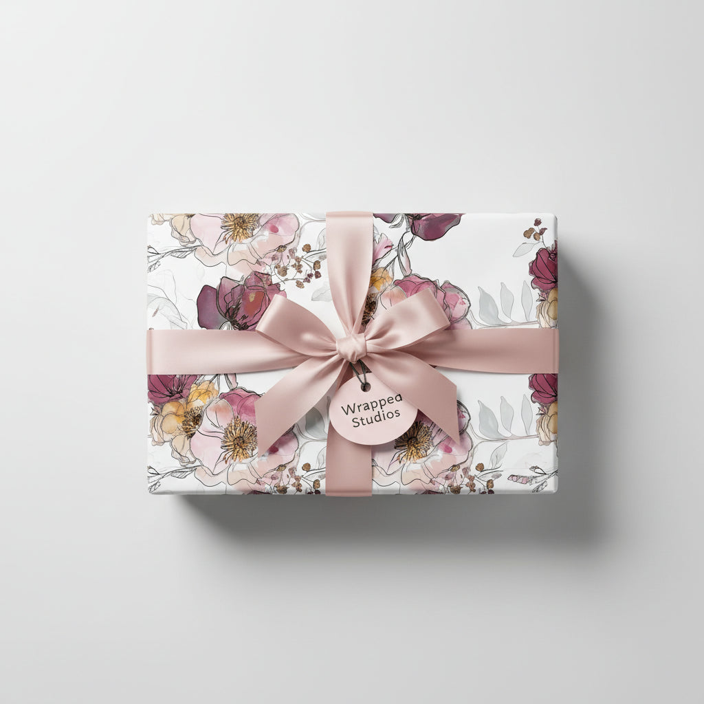 Elegant gift wrapped in modern floral wrapping paper with a blush satin ribbon and bow.