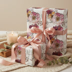 Elegant floral wrapping paper with pink ribbons on gifts, ideal for birthdays or special occasions.