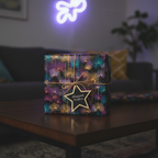 Modern floral wrapping paper in teal, gold and purple, tied with twine on a gift box, with a star tag.