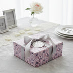 Elegant gift wrapped in mauve floral wrapping paper with a gray satin ribbon and "Celebrating your love" tag.