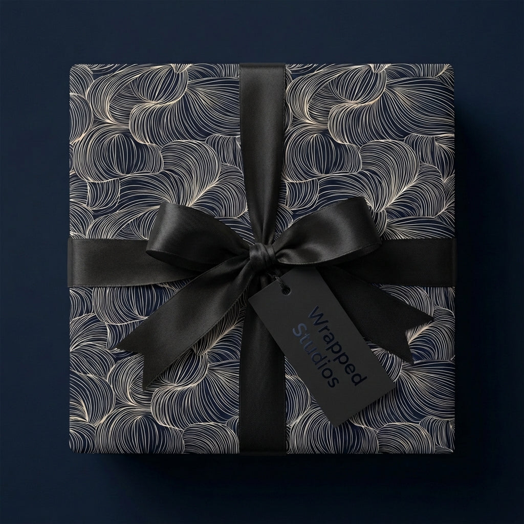 Elegant Wrapped Studios gift with navy/gold swirl wrapping paper and black satin ribbon.
