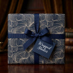 Elegant navy gift wrap with gold line pattern and matching ribbon from Wrapped Studios.