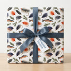 Fly fishing wrapping paper with trout and lures, tied with a blue satin ribbon, by Wrapped Studios.