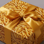 Square gift wrapped in French fry pattern paper with a gold satin ribbon and bow.