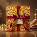 Square gift wrapped in french fry print paper, tied with a burgundy ribbon and bow.