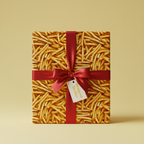 French fry wrapping paper on a gift box tied with a red ribbon.