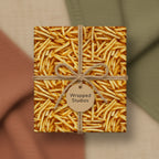 Funny gift wrap: Square box wrapped in french fries pattern paper with twine bow and tag.
