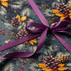 Christmas gift wrap: pine cones, berries, and gold holly on dark blue with a purple satin bow.