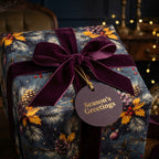 Elegant Christmas gift wrap with pinecone floral pattern, velvet bow, and "Season's Greetings" tag.