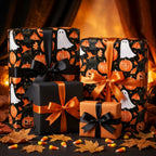 Spooky Halloween wrapping paper with ghosts and pumpkins on gift boxes with satin bows by Wrapped Studios.