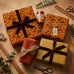 Assorted gift boxes with wrapping paper and ribbon, one bizarrely featuring pork and beans design.