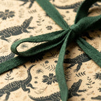 Kraft alligator & botanical wrapping paper with forest green ribbon. Perfect for kids' birthday or baby shower gifts.