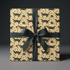 Tan alligator wrapping paper with black floral pattern, tied with a black satin bow. Unique luxury gift wrap.