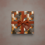 Abstract patterned wrapping paper in neutral tones with a rust-colored ribbon and "Artful Gifting" tag.