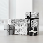 Modern minimalist gift wrapping paper set in black, white, and grey with unique pebble pattern, satin ribbons, and "Thank You" tags.