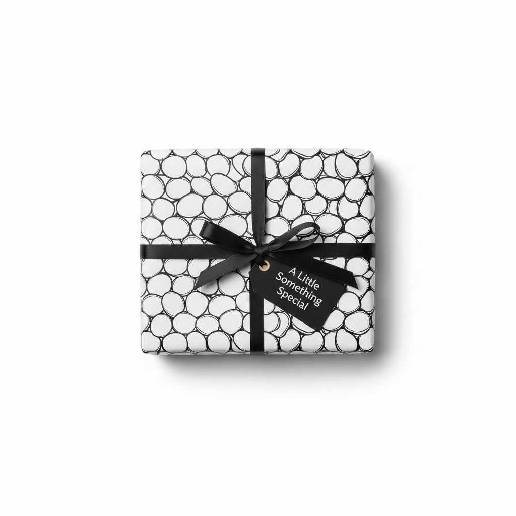 Modern black and white bubble pattern wrapping paper with a black ribbon bow and a "A Little Something Special" gift tag.