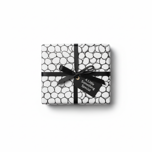 Modern black and white bubble pattern wrapping paper with a black ribbon bow and a "A Little Something Special" gift tag.