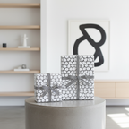 Modern black and white abstract circle wrapping paper with striped ribbon, perfect for minimalist luxury gifts.