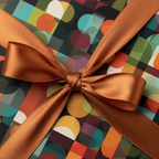 Modern geometric wrapping paper with a copper satin ribbon bow.