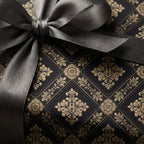 Elegant black and gold damask wrapping paper with a grey satin ribbon bow by Wrapped Studios.
