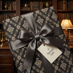 Luxury vintage wrapping paper in black and gold damask with a grey ribbon by Wrapped Studios.