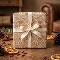 Rustic kraft heart wrapping paper with a cream ribbon bow by Wrapped Studios.