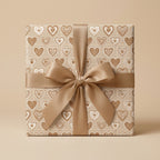 Boho beige heart wrapping paper with a gold satin bow, luxury wedding gift wrap by Wrapped Studios.