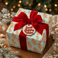 Gingerbread Christmas gift wrap by Wrapped Studios on a holiday present with a red velvet bow.