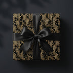 Black and gold circuit board wrapping paper with a satin ribbon bow on a gift box, by Wrapped Studios.