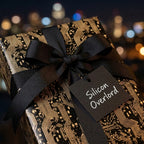 Geeky black and gold circuit board gift wrap with a black ribbon by Wrapped Studios.