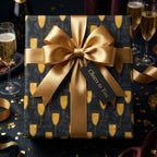 Luxury black and gold champagne wrapping paper with a large satin bow by Wrapped Studios.