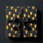 Luxury gold champagne glass wrapping paper with a black satin bow, by Wrapped Studios.