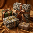 Elegant ginkgo wrapping paper on luxury gift boxes with bronze ribbons by Wrapped Studios.