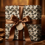 Elegant ginkgo leaf wrapping paper with a brown satin bow on a gift box by Wrapped Studios.