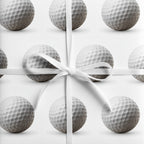 Golf ball wrapping paper with white ribbon bow.
