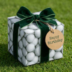 Golf wrapping paper with golf ball pattern, green velvet bow, and birthday tag by Wrapped Studios.