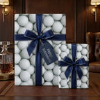 Golf wrapping paper with navy blue ribbons and a Happy Retirement tag by Wrapped Studios.