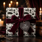 Gothic skull wrapping paper with a burgundy velvet bow and Til Death tag by Wrapped Studios.