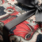 Gothic dragon wrapping paper featuring red dragons and winter flowers tied with a black ribbon by Wrapped Studios.