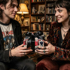 Gothic dragon wrapping paper with black bow held by a smiling couple, from Wrapped Studios.