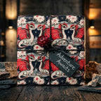 Fantasy red dragon gift wrap with an Adventure Awaits tag and black twine by Wrapped Studios.