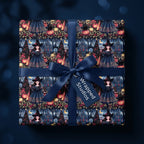 Gothic witch Halloween wrapping paper on a gift box with a navy bow, by Wrapped Studios.