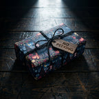 Gothic witch Halloween wrapping paper on a box with a wooden gift tag, from Wrapped Studios.