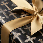 Elegant black and gold cross wrapping paper with a satin ribbon for baptism by Wrapped Studios.