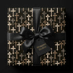 Gothic cross wrapping paper with a black satin bow on a luxury gift box by Wrapped Studios.
