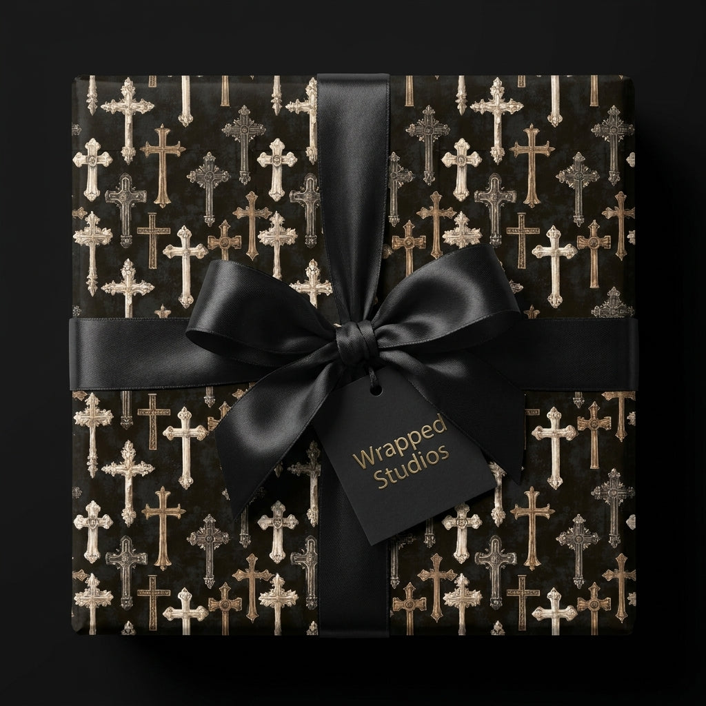 Gothic cross wrapping paper with a black satin bow on a luxury gift box by Wrapped Studios.