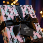 Elegant pastel goth wrapping paper with black damask print and a satin bow by Wrapped Studios.