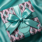 Pink and teal gothic damask wrapping paper with a luxury satin bow and "Celebrate" tag by Wrapped Studios.
